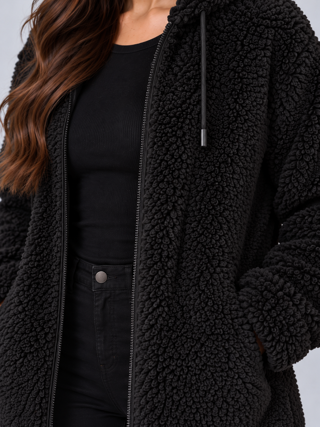 Close-up of black teddy borg fleece with front zip and drawstring
