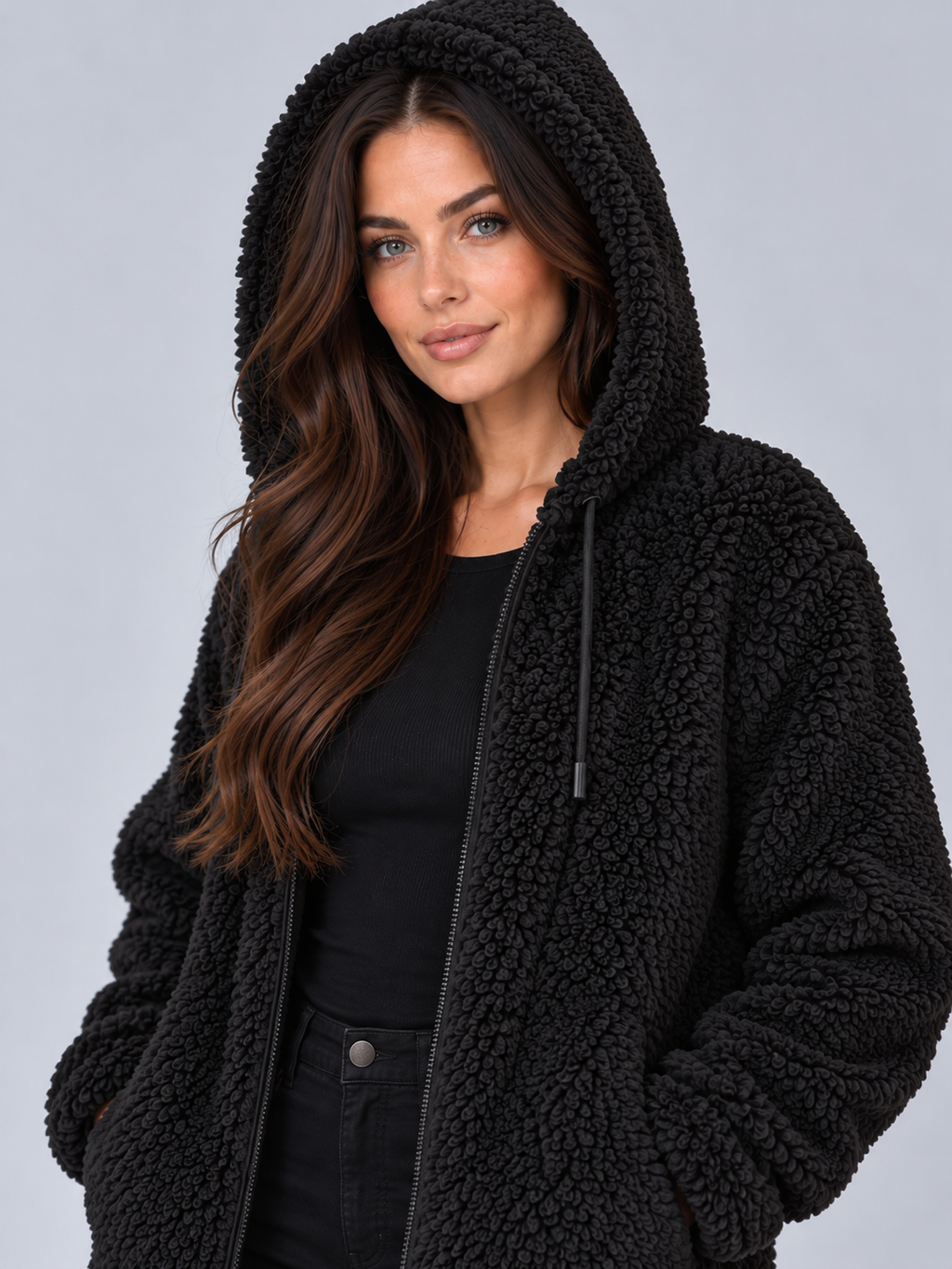 Women's fluffy teddy borg hooded jacket in black, worn with the hood up